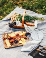 A full set of six Esie Houzie stainless steel cheese knives with acacia wood handles, neatly arranged in their storage bag.