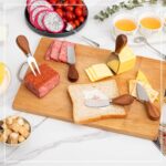 A complete 14-piece set of GUZE-US charcuterie utensils, including cheese spreaders with wood handles, mini spoons, forks, an