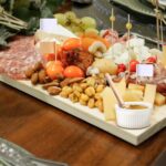 A 29-piece charcuterie board accessory set including various cheese knives, mini serving spoons, forks, tongs, and small bowl
