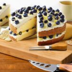 A 6-piece KT-GARY cheese knife set with various stainless steel blades and light-colored bamboo wood handles, arranged neatly