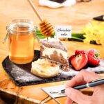 A complete 23-piece LifeMusican charcuterie board accessory set with wooden handles, including various cheese knives, spreade