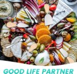 A complete 23-piece LifeMusican charcuterie board accessory set with wooden handles, including various cheese knives, spreade