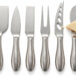 A silver 6-piece RWIXR cheese knife set neatly arranged, featuring various knives, spreaders, and a fork.