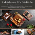 Square acacia wood charcuterie board with ceramic dishes and stainless steel cheese knives, ready for serving.