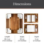 Square acacia wood charcuterie board with ceramic dishes and stainless steel cheese knives, ready for serving.