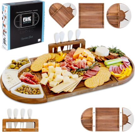 A large, brown acacia wood charcuterie board set with cheese knives and ceramic dishes, displaying a spread of snacks.