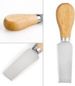 A set of four silver stainless steel cheese knives with wooden handles, arranged on a charcuterie board.