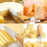 A set of four silver stainless steel cheese knives with wooden handles, arranged on a charcuterie board.