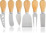A set of four silver stainless steel cheese knives with wooden handles, arranged on a charcuterie board.